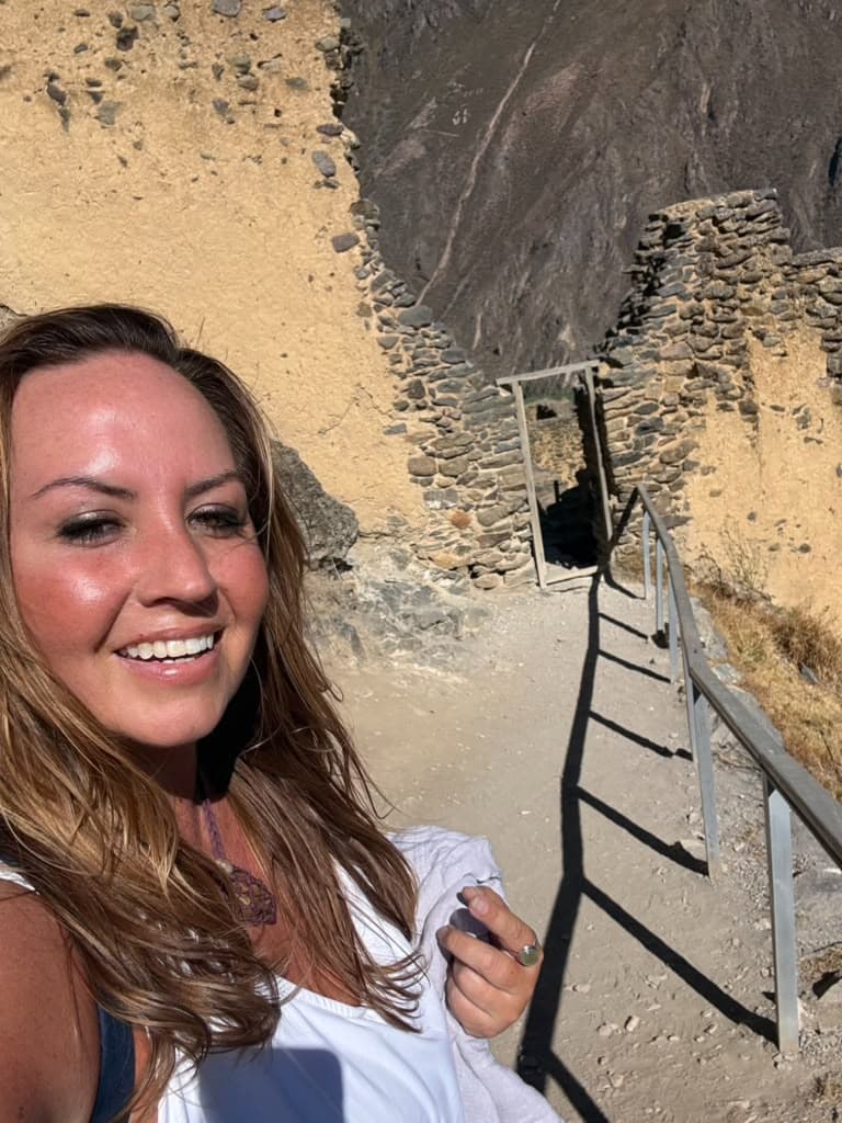 Sarah on the stone stairway below the gate of Ollantaytambo