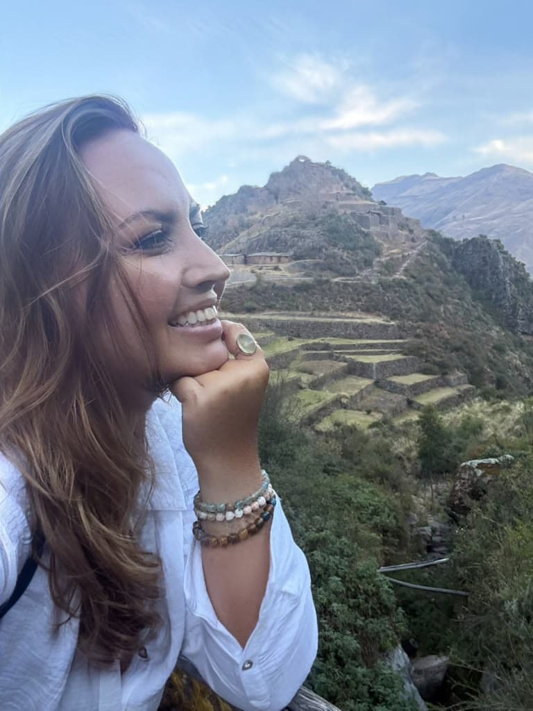 Sarah resting her chin on her hand above the terraces of Pisac