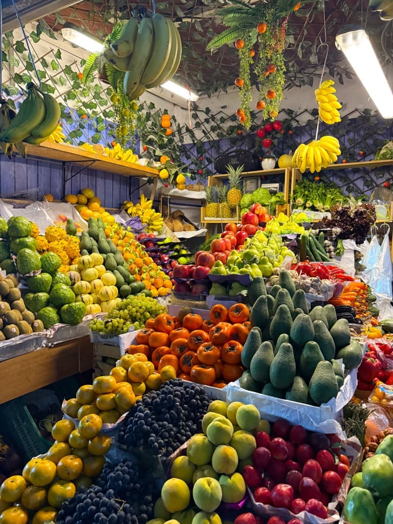 A vibrant Lima market stall piled high with tropical fruit in every color